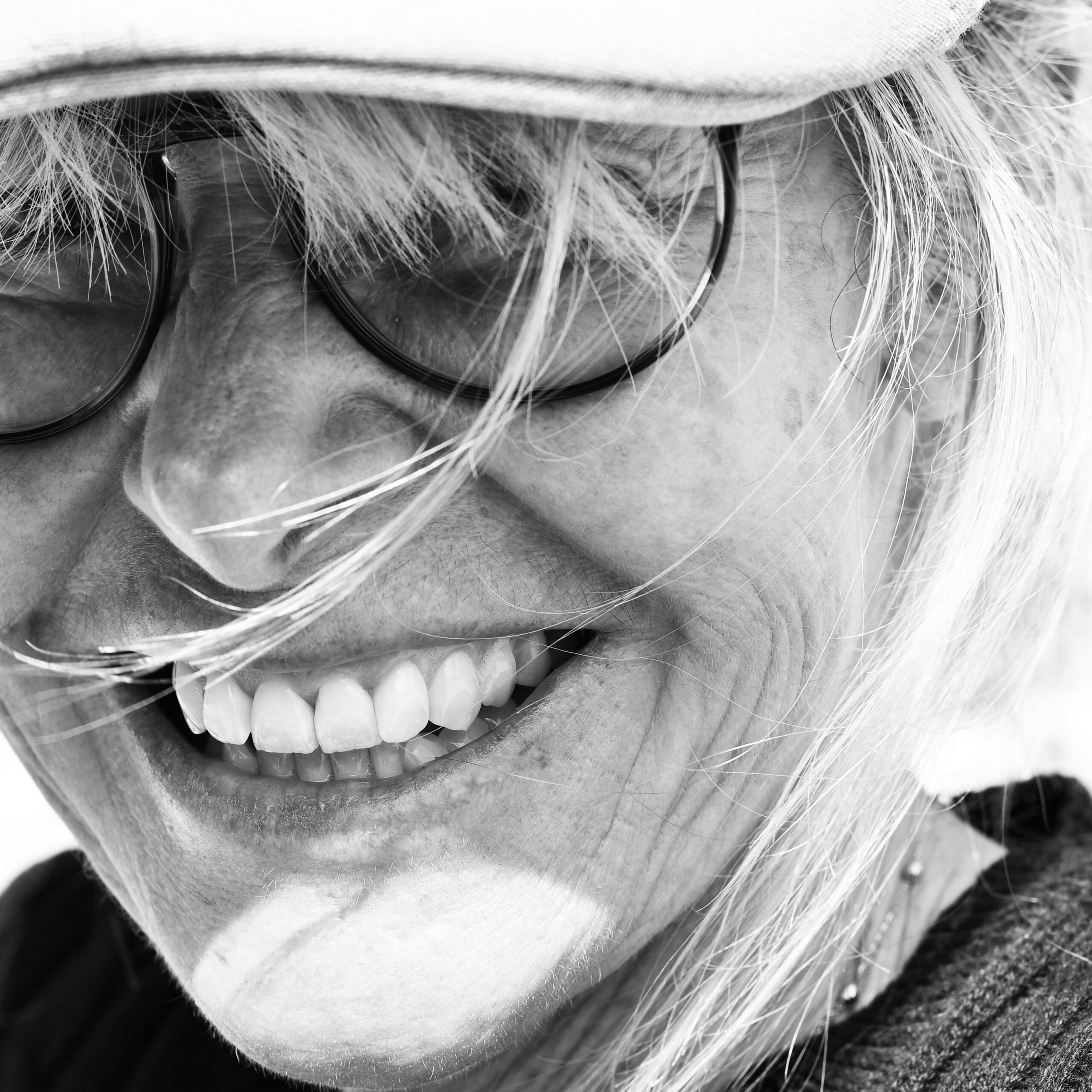 Bright Smile of a Happy Woman After Dental Implants Confidence Restored Close-up of an older woman smiling confidently, showing perfect teeth after dental implants